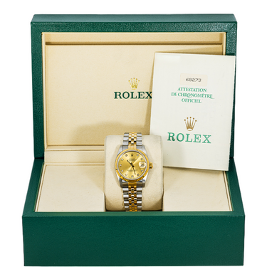 Rolex watch in a green box with a certificate of authenticity