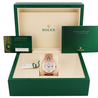 Rolex watch in a green box with the Rolex logo.
