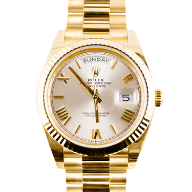 Gold Rolex watch with a white face on a white background