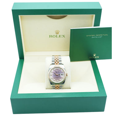 Rolex watch in an open green box with the Rolex logo visible.