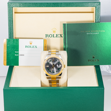 Rolex watch in a green box with branding
