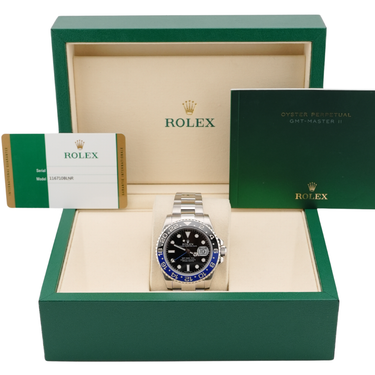 Rolex watch in a green and beige box with the Rolex logo.