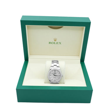 silver watch on a Rolex box