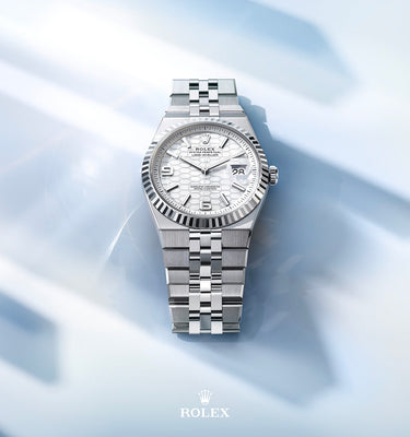 silver watch on a light blue background