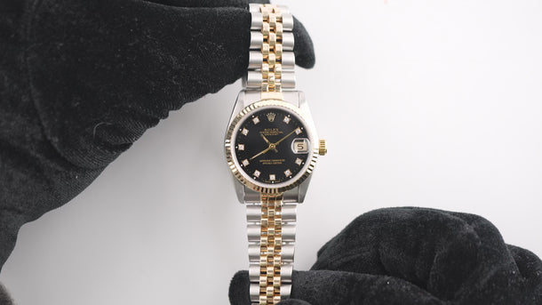 Tow tone Rolex 68273 Datejust 31 mm watch with a Fluted Bezel, Black Diamond Dial, and Jubilee Bracelet  on a white background