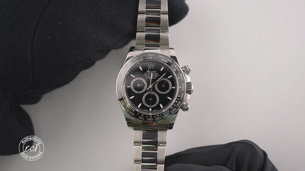 Silver watch with black dial on a white background