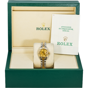 Rolex watch in green box with gold and silver watch face