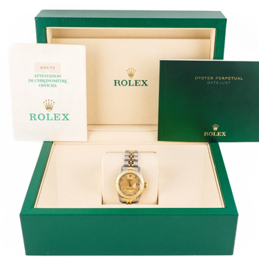 Rolex watch in a green box with the Rolex logo visible