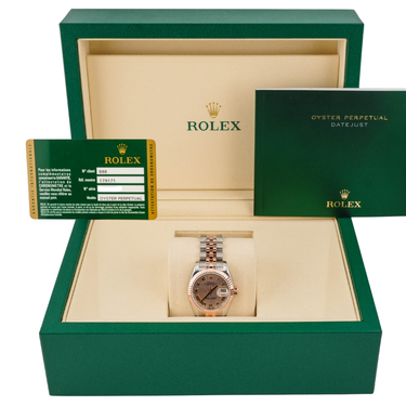 Rolex watch in a green box with the Rolex warranty card