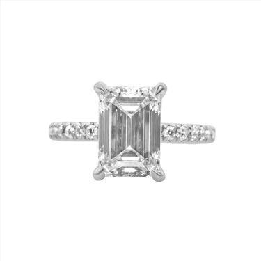 A 14k white gold ladies' emerald-cut diamond engagement ring with a total carat weight of 2.75, featuring a main emerald-cut diamond and smaller round-cut accent diamonds set in a prong-set design along the band.